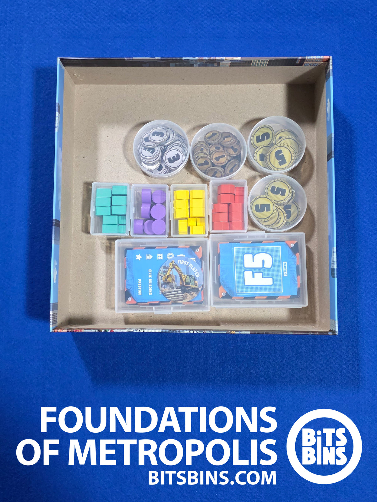 Open Foundations of Metropolis box with the BitsBins organizer set inside: Pods of coins, Minis of player pieces and Card Boxes of deed cards.