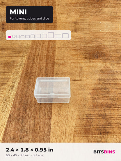 Single BitsBins Mini container on a wood table. For tokens, cubes and dice. 2.4 x 1.8 x 0.95 in (60 x 45 x 25 mm).