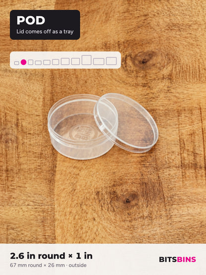 Single BitsBins Pod on a wood table with its lid off beside it. The lid comes off so the Pod works as a tray. 2.6 in round x 1 in (67 x 26 mm).