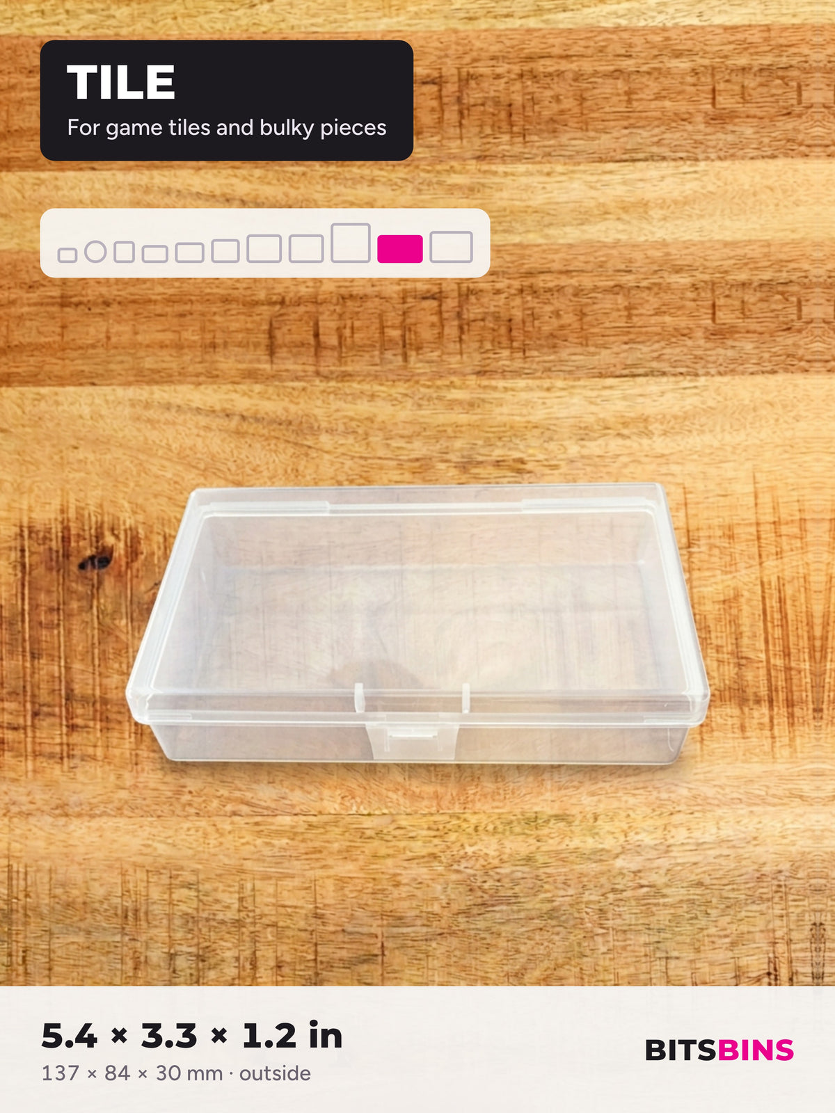 Single BitsBins Tile container on a wood table. For game tiles and bulky pieces. 5.4 x 3.3 x 1.2 in (137 x 84 x 30 mm).