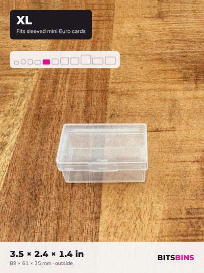 Single BitsBins XL container on a wood table. Fits sleeved mini Euro cards. 3.5 x 2.4 x 1.4 in (89 x 61 x 35 mm).