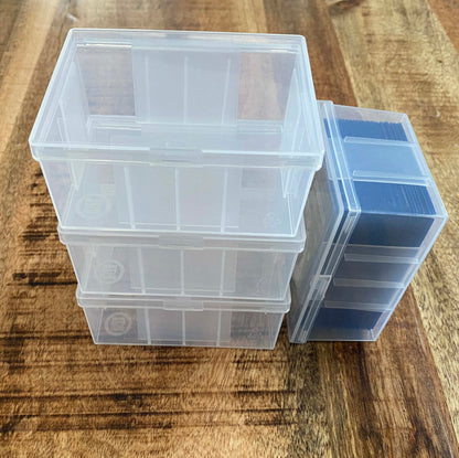 4 card boxes and one has a deck of sleeved cards